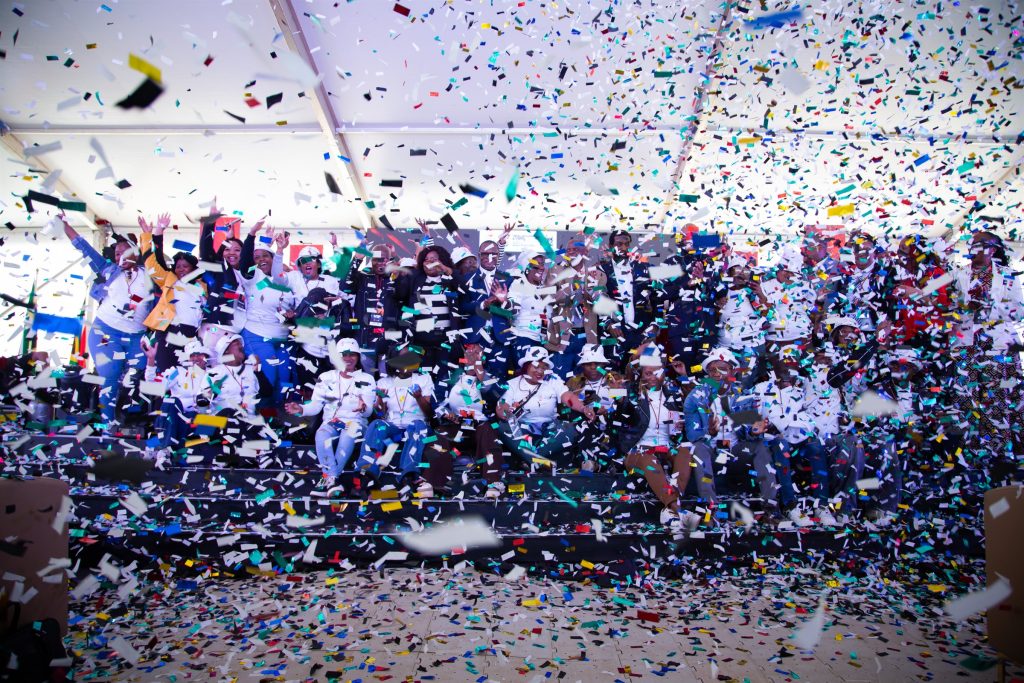 Participants celebrating with confetti on stage at the To The Power of X² North West launch in Mahikeng.