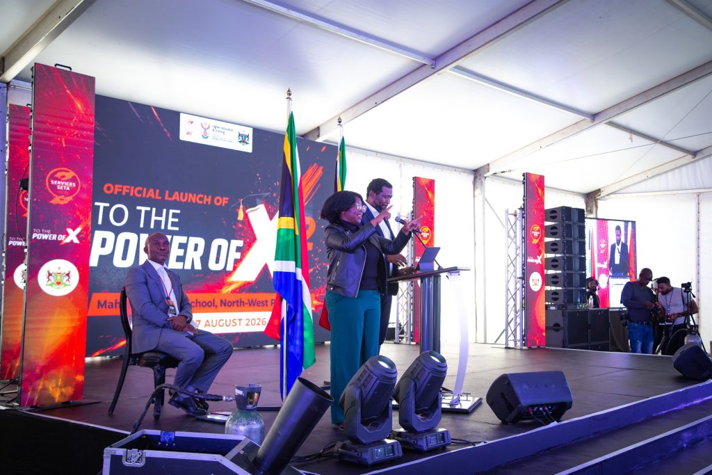 Speakers addressing attendees from the stage at the To The Power of X² North West launch in Mahikeng.
